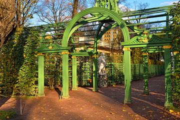 Arches and marble statue  in Summer garden.