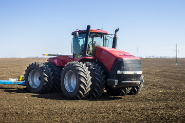 Obraz premium tractor in the field sow
