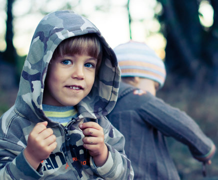 Small smiling boy in a hoodie