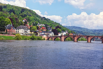 Fototapeta na wymiar Quay and bridge over river in summer Heidelberg