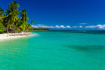 Tropical island in Fiji with sandy beach and clean water