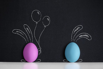 Easter eggs witn painted Easter Bunny on the blackboard - 80934799