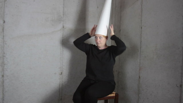 Woman in Dunce Cap Making Faces