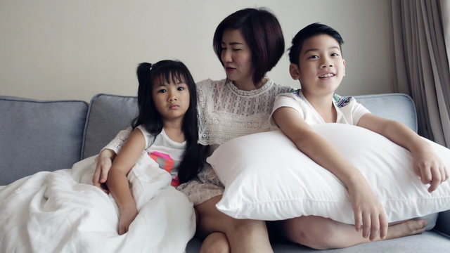 Young Asian family playing and Watching TV .