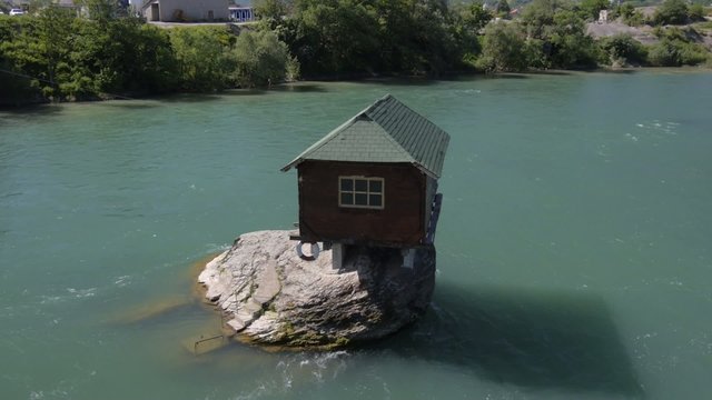 small house built on the rock in the river Drina