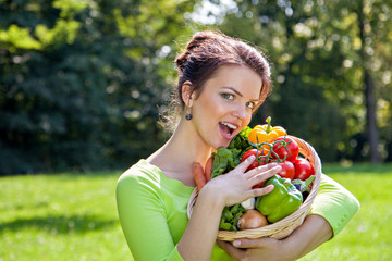Young brunette woman with basket full of healthy food