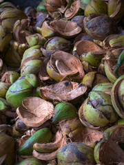 Textured background of stack of hairy brown coconuts
