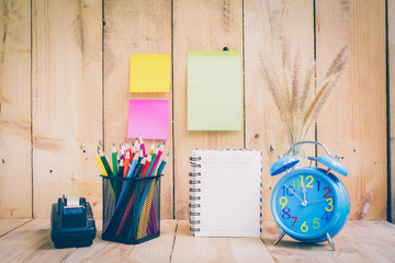 Color pencils and note book on wooden background - Vintage effec