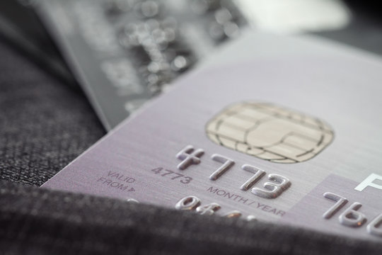 Credit cards in very shallow focus with gray suit background