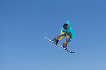Snowboarder jumps in Snow Park