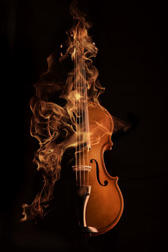violin on fire over black bg