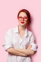 Smiling student girl in white shirt and red glasses