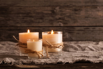 scented candles on old wooden background