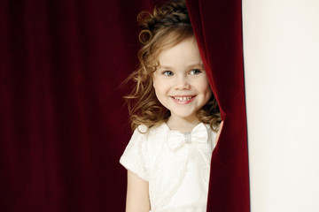 Portrait of cheerful pretty girl with ringlets
