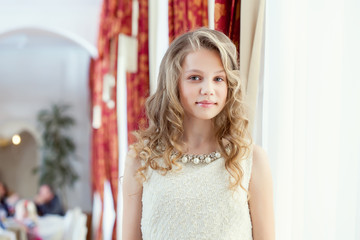 Image of pretty smiling girl posing in restaurant