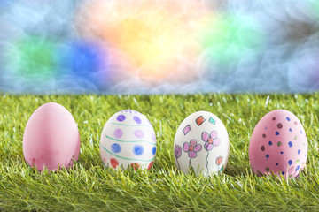 Easter eggs lying on the meadow with bokeh