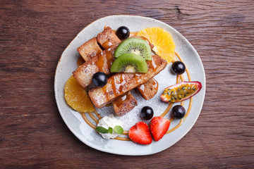 French toast and fresh fruit with caramel sauce