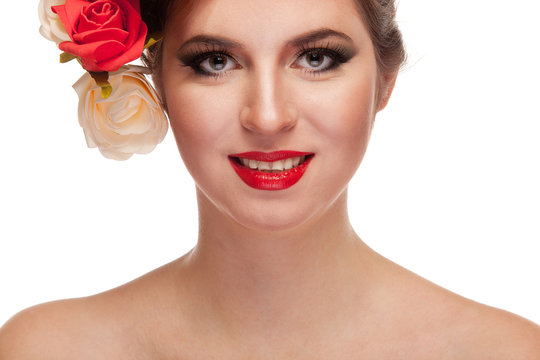 Smiling woman with flowers in head on white background