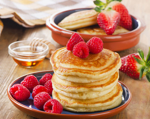 Small pancakes with raspberries and  butter
