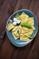 Italian ravioli with mozzarella cheese stuffing, high angle view
