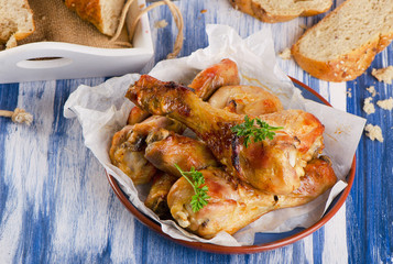 Roasted chicken legs with  bread and herbs.