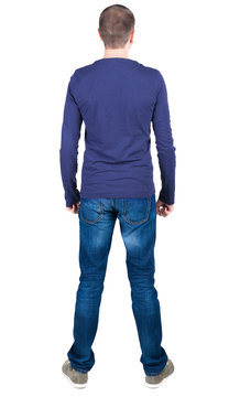 Back view of young man in t-shirt and jeans  looking.