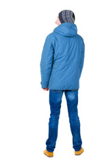 Fototapeta premium Back view of handsome man in winter jacket looking up.