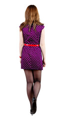 back view of going brunette woman  in blue dress.