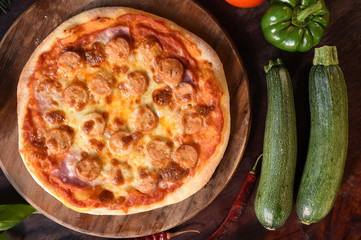 pizza and fresh vegetables for pizza on the wooden background