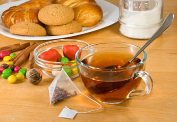 image of a cup of tea, cakes and buns