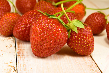 ripe and tasty strawberries on wooden table