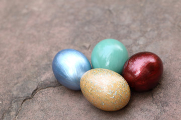 Colorful easter eggs on stone floor.