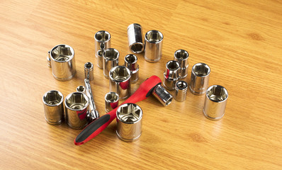 Ratchet and a set of different attachments to tighten the bolts
