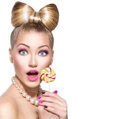 Beauty fashion model girl eating colourful lollipop