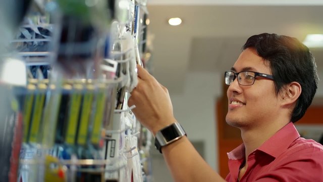 Happy Chinese Man Ordering Usb Drive In Computer Shop