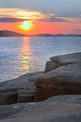 Sunset view from a rock by the sea