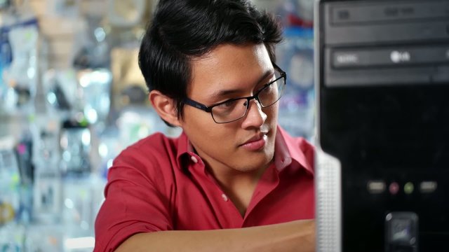 Portrait Of Chinese Man Reparing PC In Computer Shop