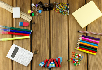 School and office supplies on wooden background