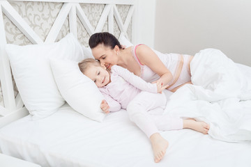 Mother and daughter in bed