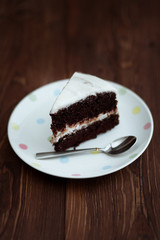 Chocolate cake in white plate on wooden table