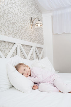 Little child girl in soft bed