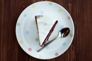 Chocolate cake in white plate on wooden table