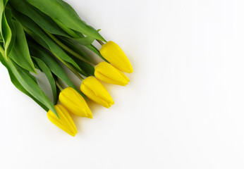 Top view of yellow tulips with blank blackboard