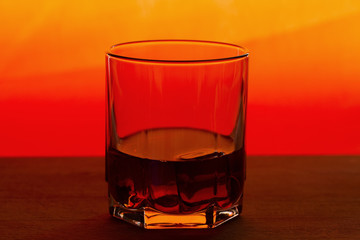 whiskey with ice on a wooden table