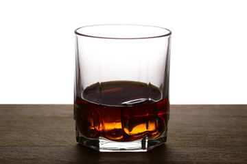whiskey with ice on a wooden table