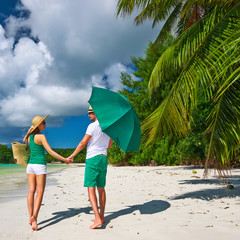 Couple in green on a beach at Seychelles