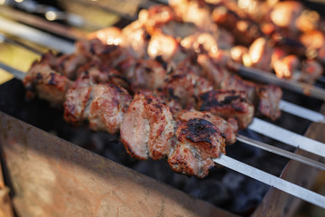 cooking pork shashlik on skewer in mangal outdoor food