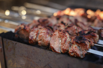 cooking pork shashlik on skewer in mangal outdoor food