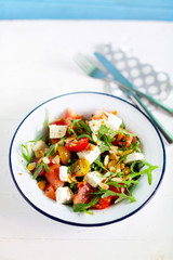 Fresh watermelon salad with arugula, feta, olives and tomato