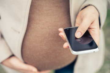 pregnant woman calling by mobile phone